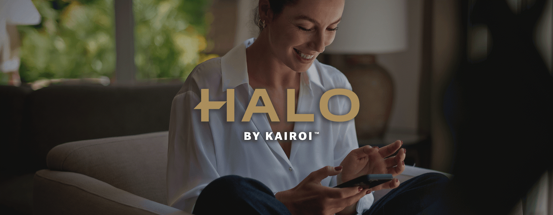 a woman smiling and looking at a phone