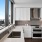 Penthouse Kitchen with GE Café Appliances, white cabinets, grey backsplash, white countertops, and Views of Downtown Austin